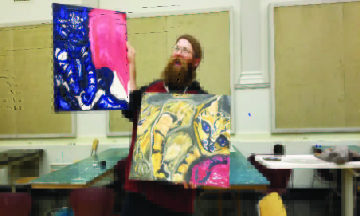 Ryan-McCormick-with-2-of-his-paintings