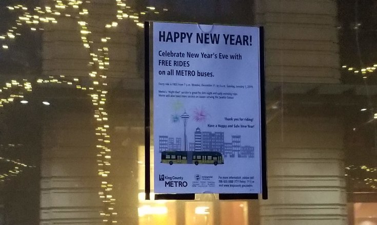 Photo of King County Metro's sign posted inside bus announcing free rides on NYE