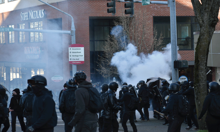 Law enforcement deploy less lethal weapons on anti-fascist-style demonstrators.
