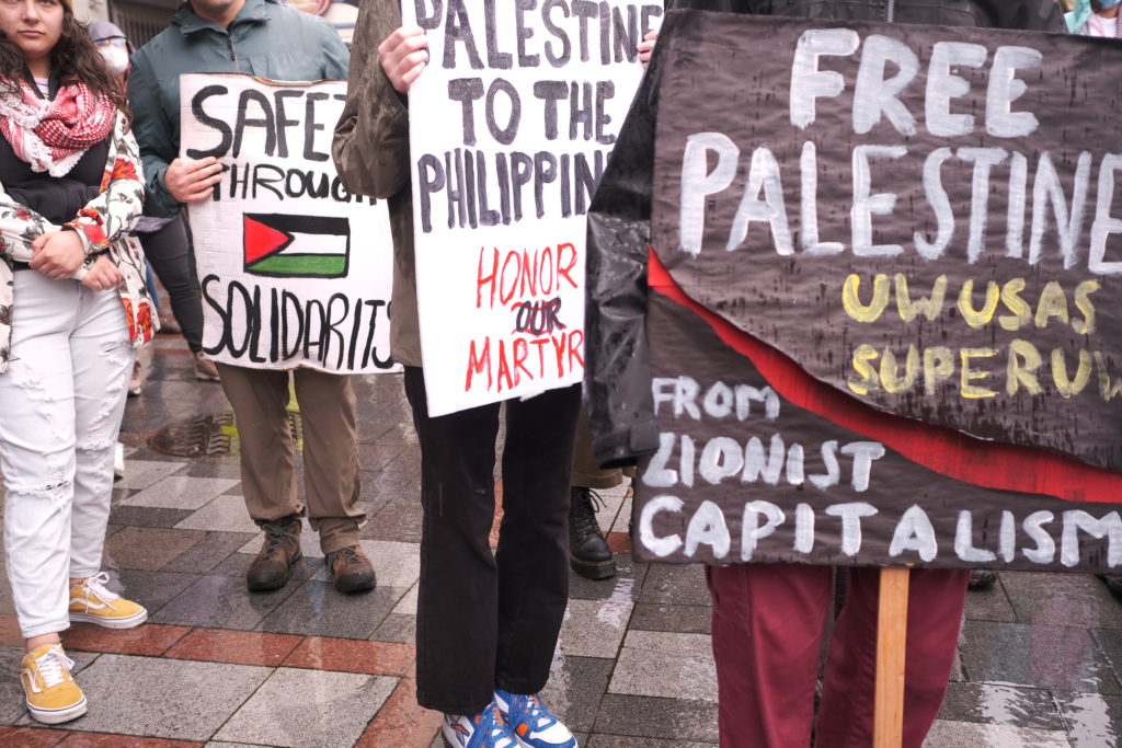 Protest signs present at the rally.