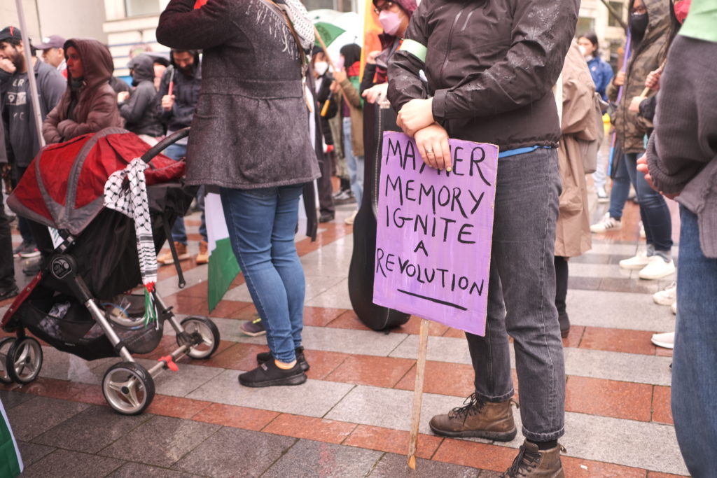 A second sign referencing the murder of Shereen Abu Aqleh by the Israeli state.